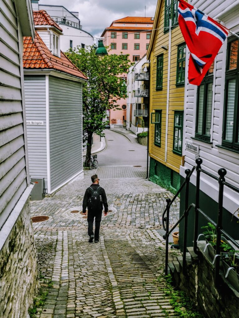 Bunte Holzhäuser-Zeile  mit Mann in Bergen