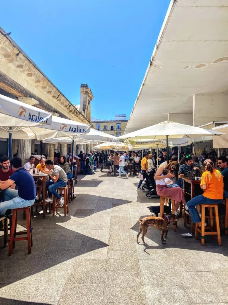 Gang mit Tischen und Menschen im Mercato Central de Cádiz